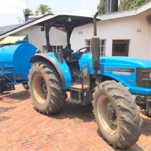 Blue Tractor pulling a blue trailer at TowTruck24 Zim Workshop in Umwinsdale